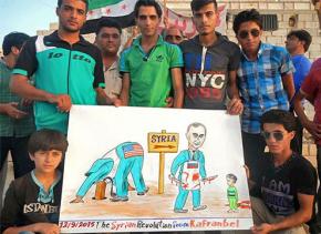 People from the Syrian town of Kafranbel protest the Assad dictatorship's terrorism while the U.S. sticks it head in the sand